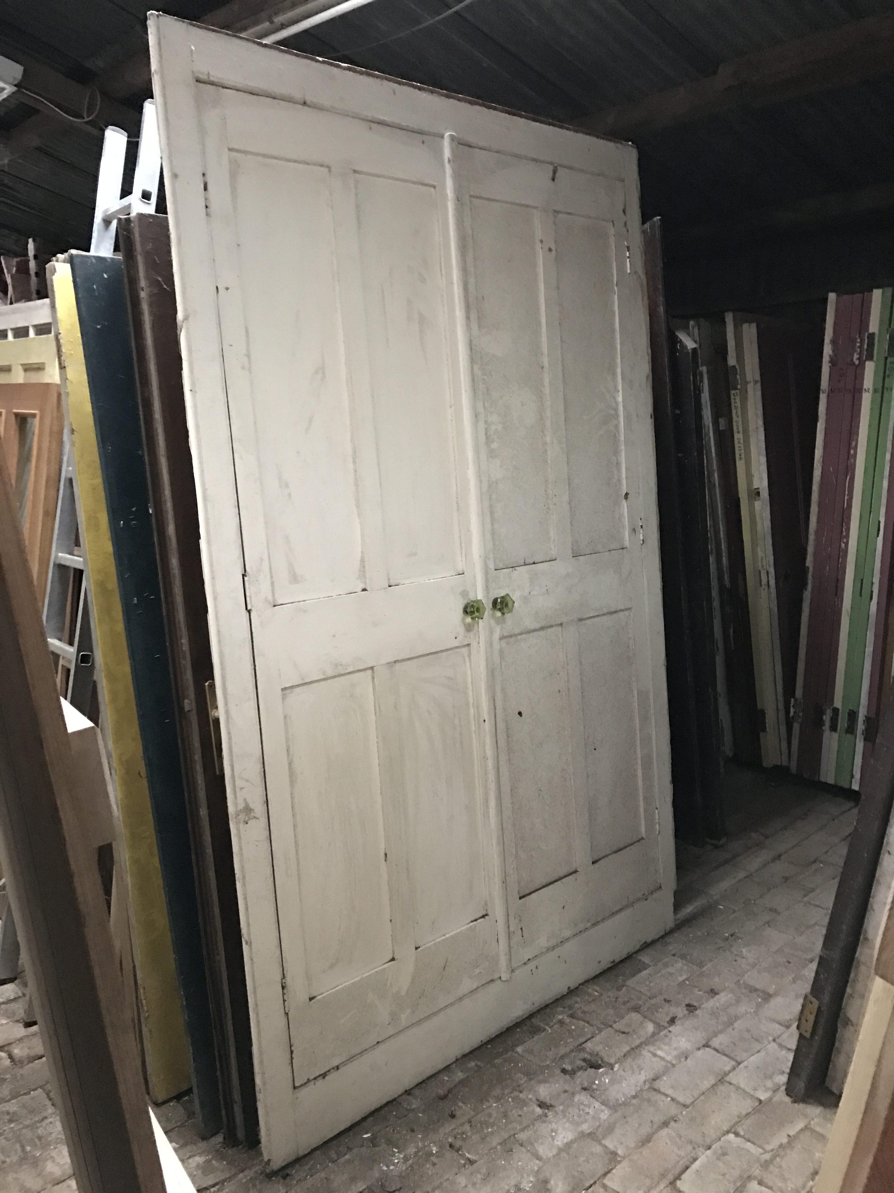 Large wooden painted white doors with frame.