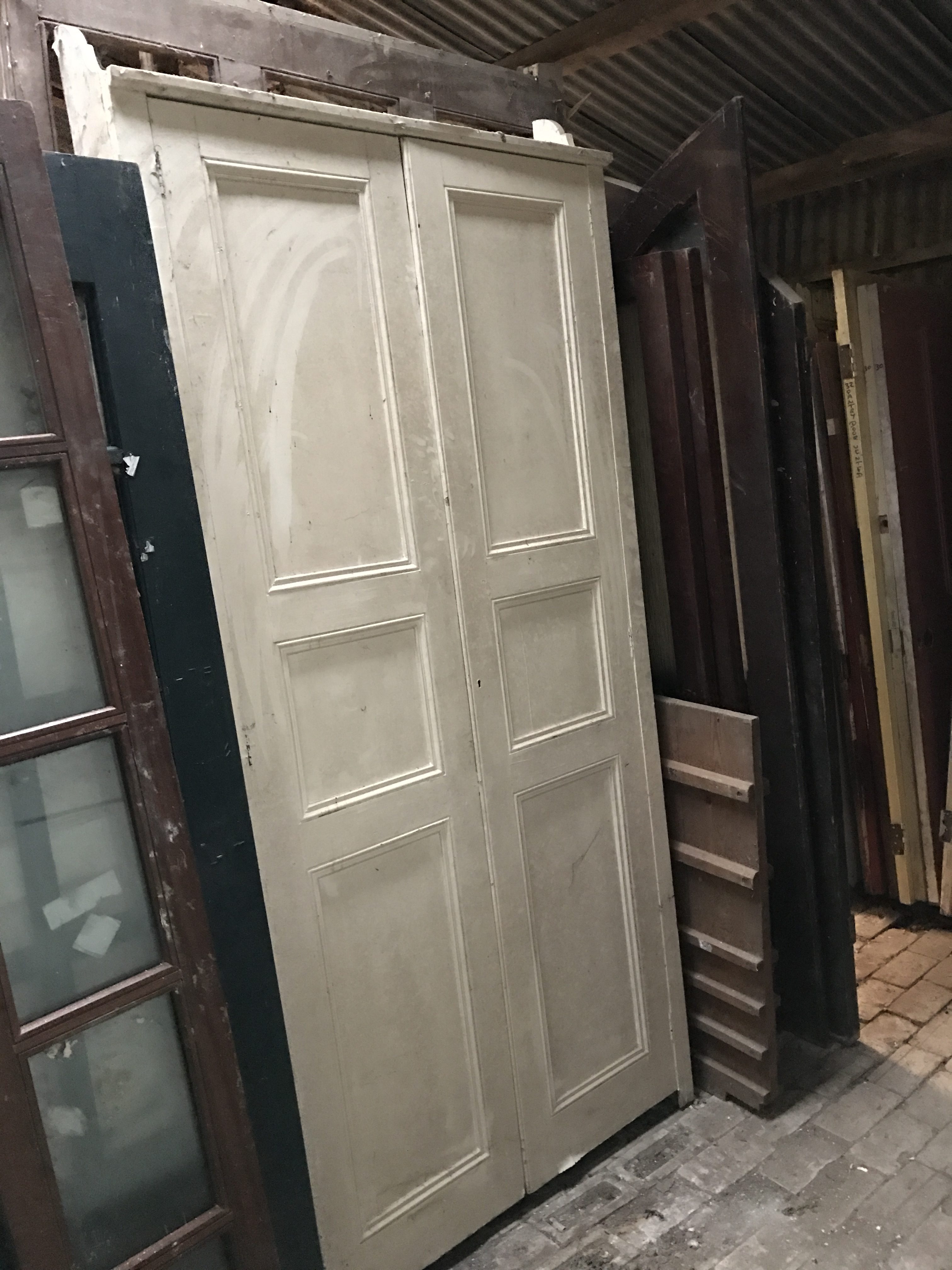 Pair of opening pannelled doors. 107cm x 215/230cm. 18cm deep.